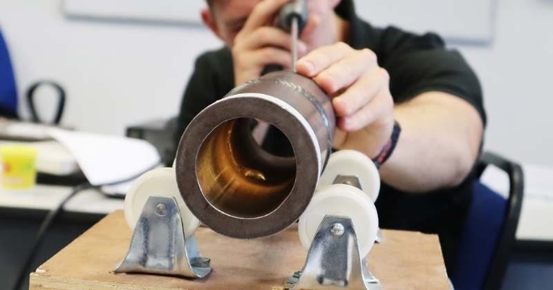 Inspector performing visual testing on welded joint